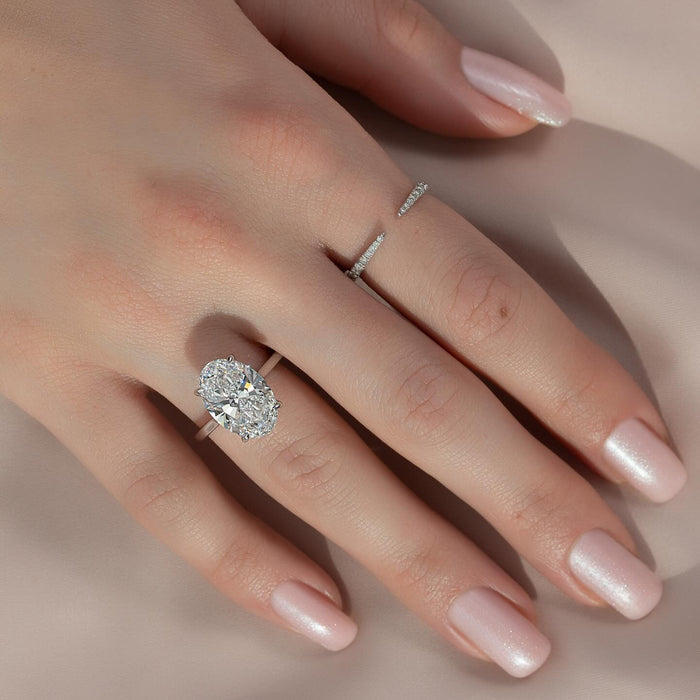Split shoulder cushion cut engagement ring worn on the hand