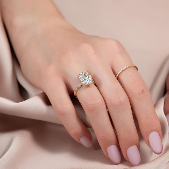 Elongated cushion cut lab grown diamond ring with hidden halo on a slim yellow gold band
