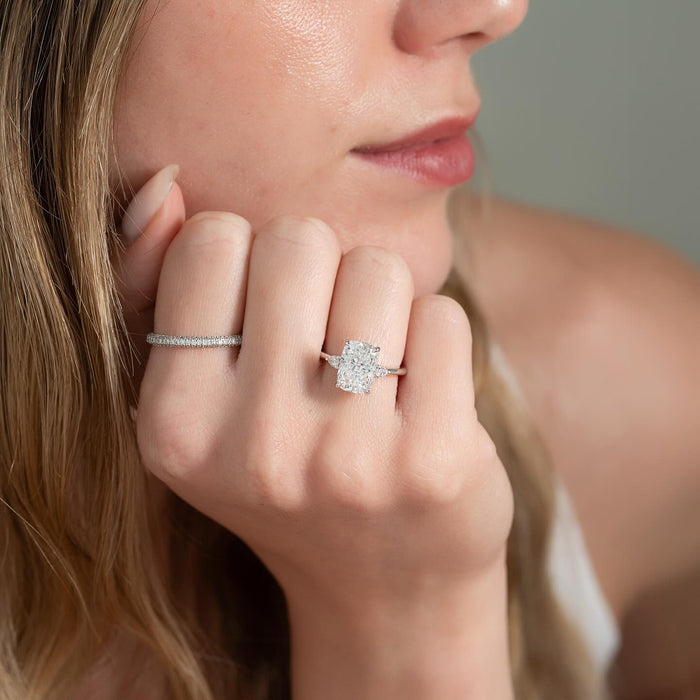 Elongated cushion cut lab grown diamond three stone ring with pear side stones in white gold