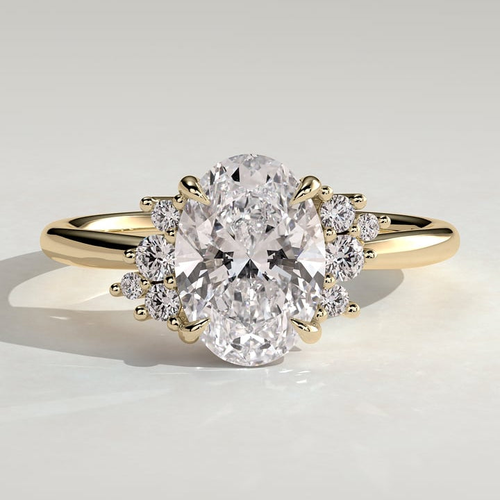 Oval cut lab grown diamond ring with graduated accent trios in yellow gold
