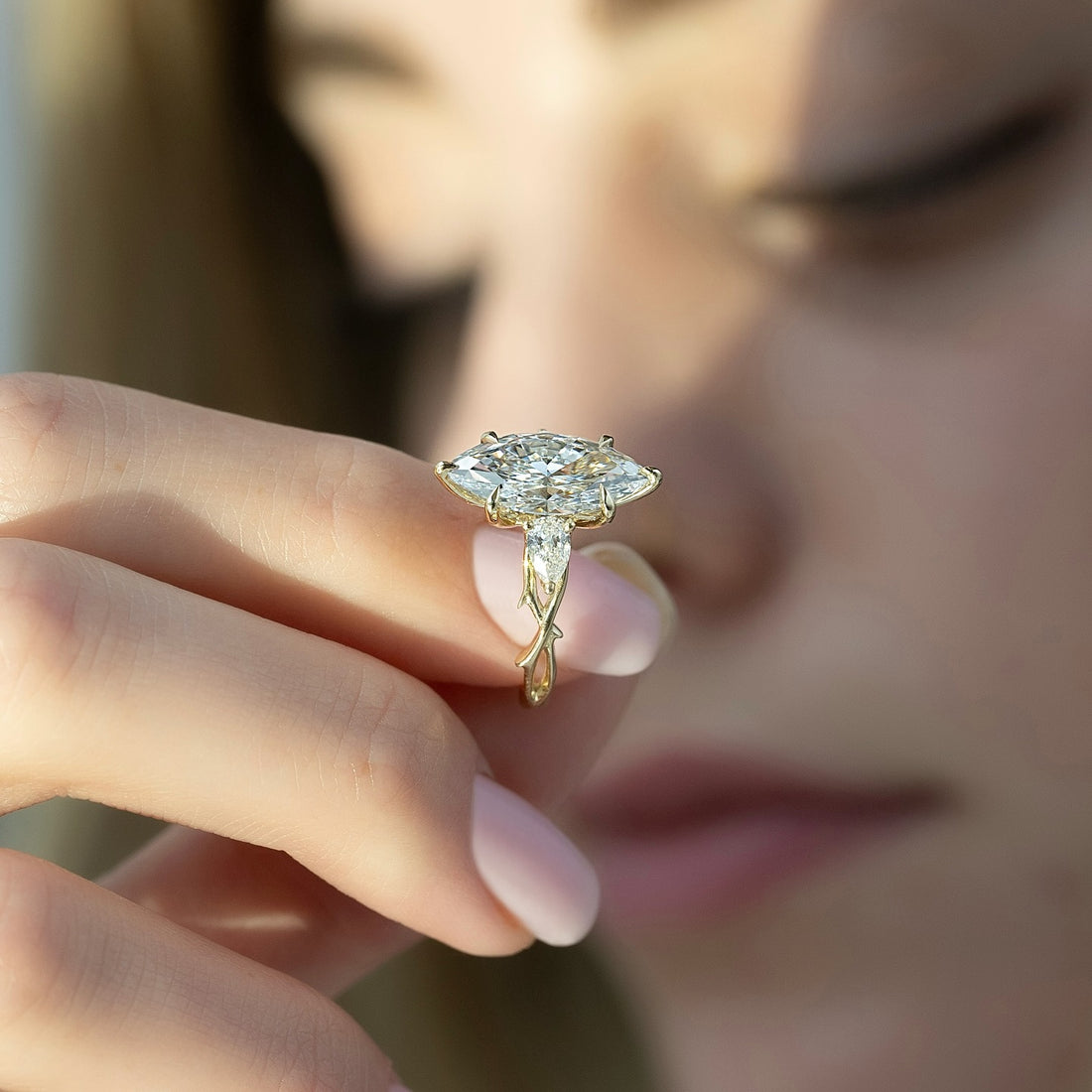 Marquise cut lab grown diamond ring on an open vine shank with pear accents in yellow gold