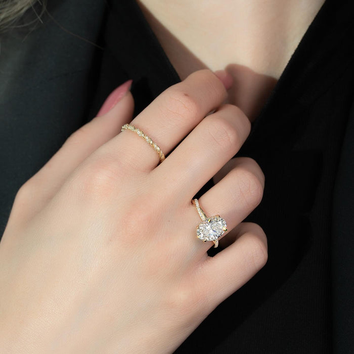 Oval diamond set across the finger with pave running into it