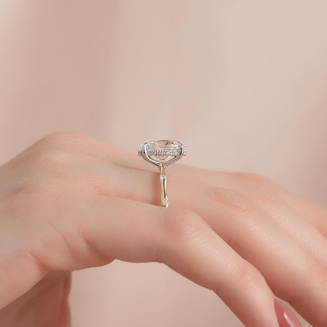 Oval cut lab grown diamond ring on a bamboo knot band in yellow gold