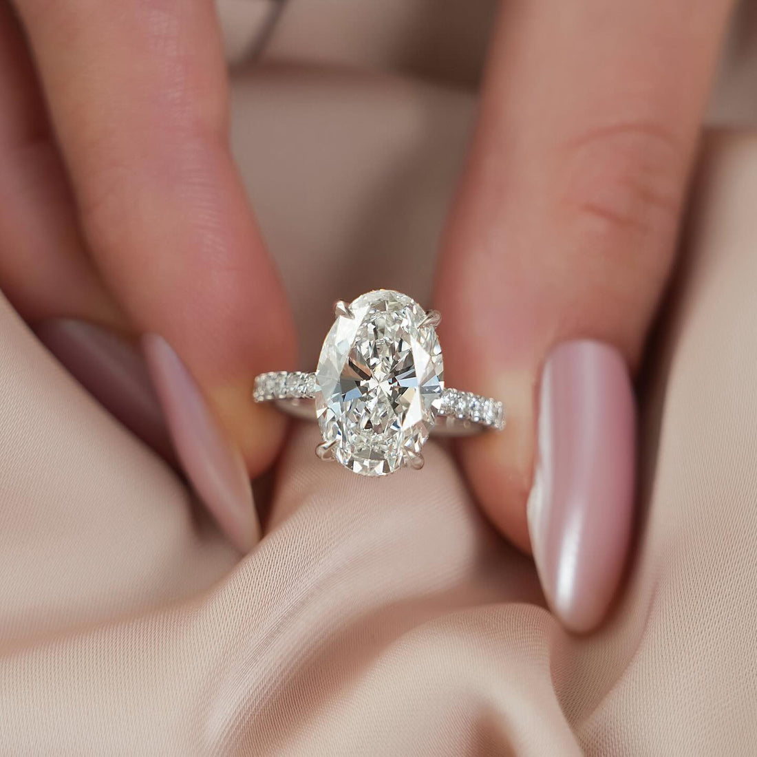 Oval cut lab grown diamond ring with graduated diamond shoulders in white gold