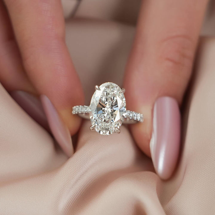 Oval cut lab grown diamond ring with graduated diamond shoulders in white gold