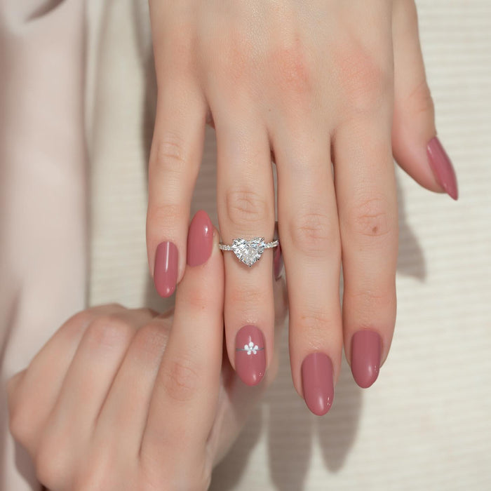 Heart shaped diamond engagement ring worn on the hand