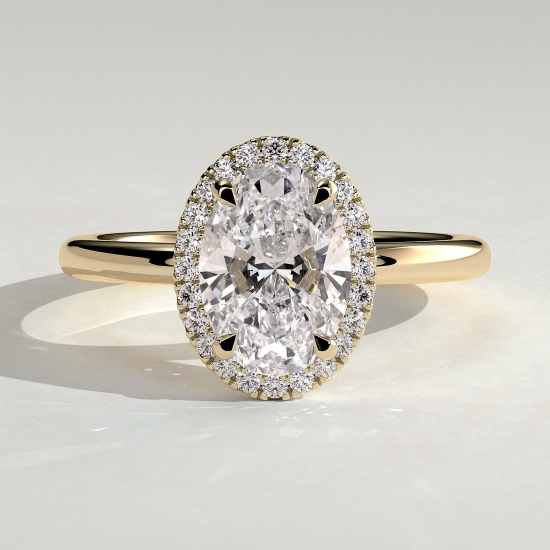 Oval cut lab grown diamond halo ring in yellow gold