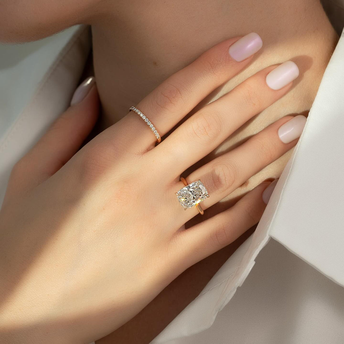 East west cushion lab grown diamond ring on a cathedral bridge in rose gold
