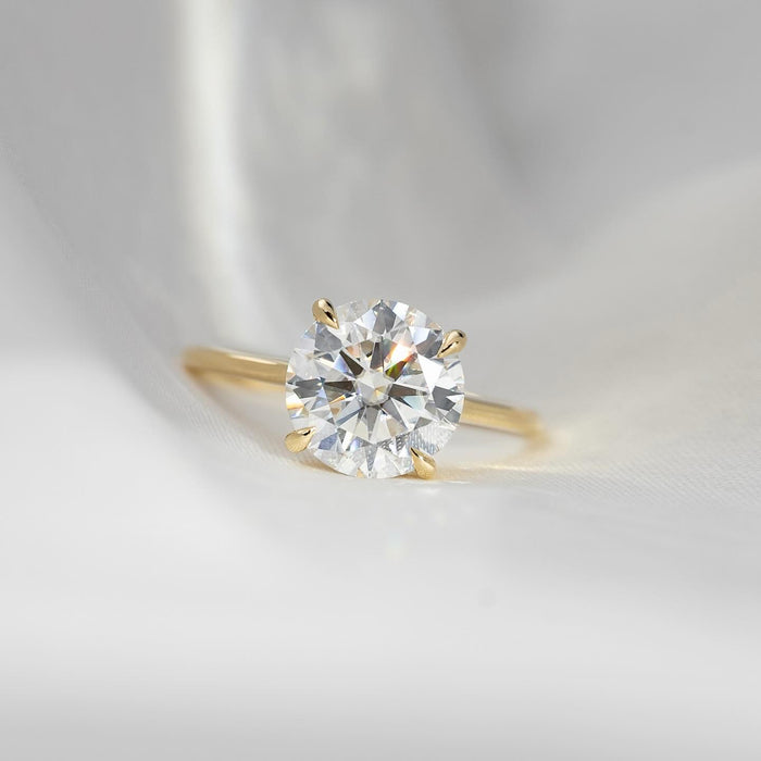 Round brilliant lab grown diamond ring on a fine plain yellow gold band