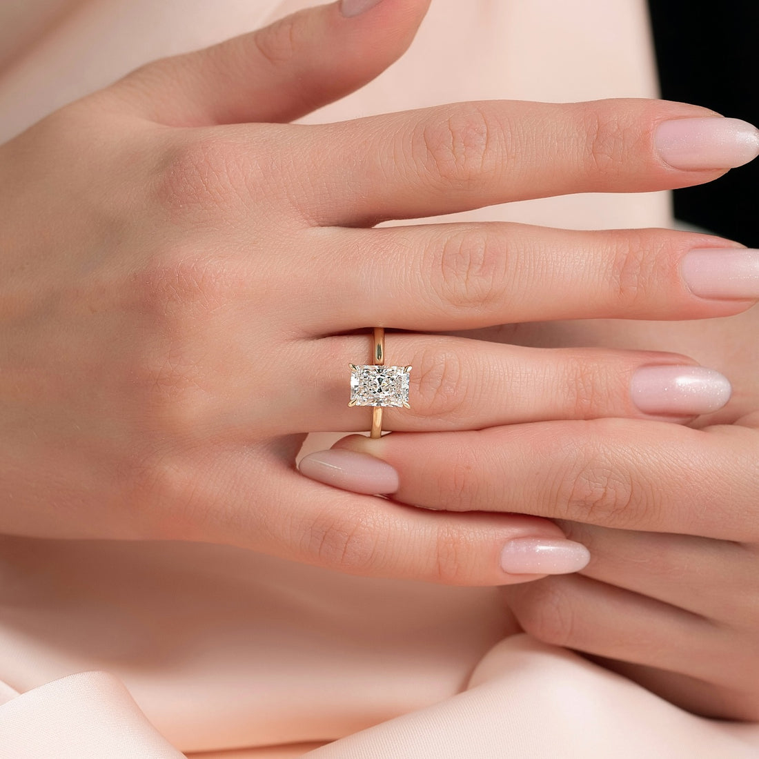East west radiant cut lab grown diamond solitaire ring on a plain rose gold band