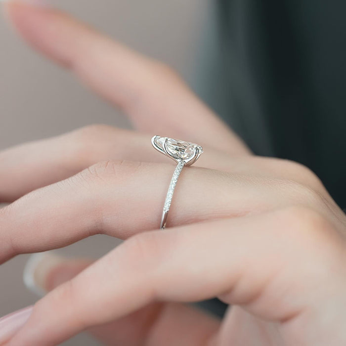 Angled view of the pear cut lab grown diamond ring showing the V tip claw and pave shank