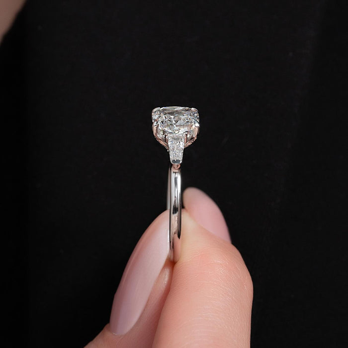 Tapered baguette side diamonds flanking the cushion centre stone