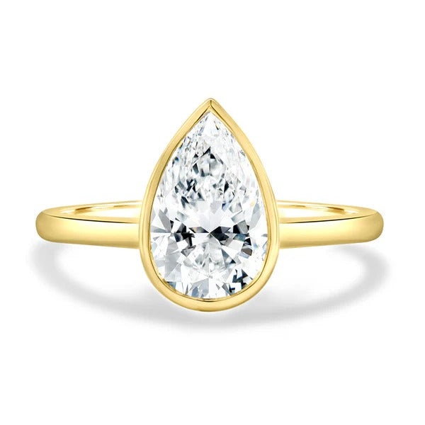 Pear cut lab grown diamond bezel set cathedral solitaire ring