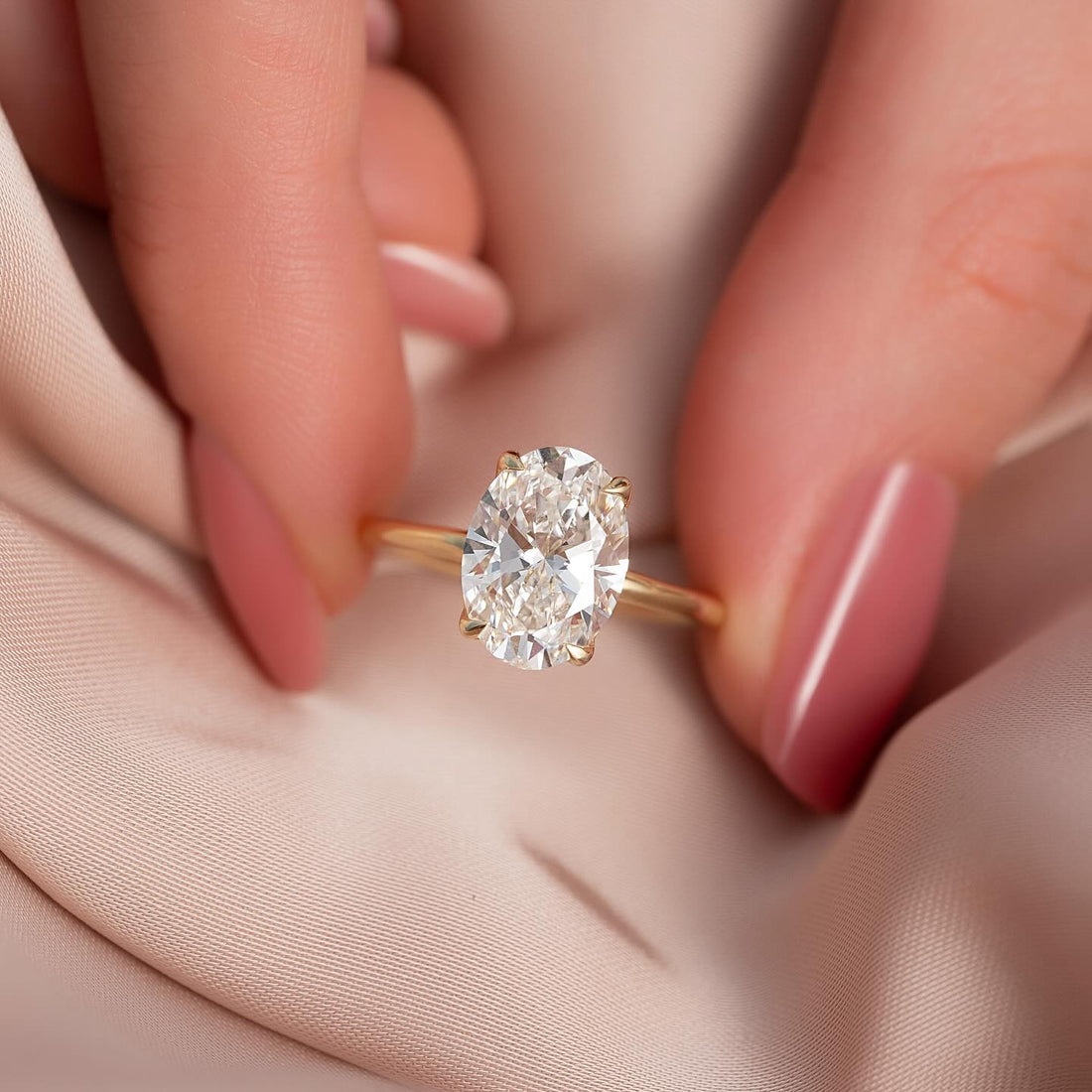 Oval cut lab grown diamond solitaire ring on a tapered plain yellow gold band