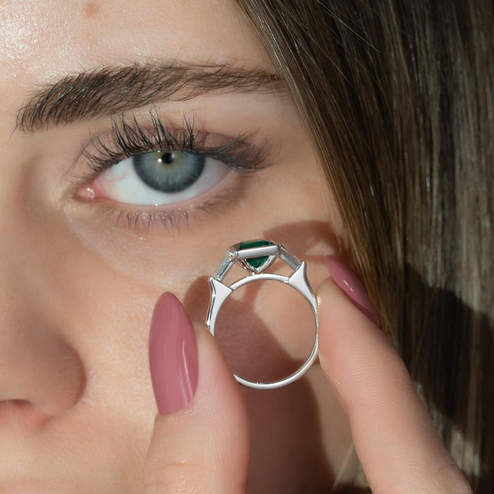 Vivid green square emerald ring worn on the hand