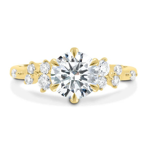 Round cut lab grown diamond six claw ring with scattered accent stones