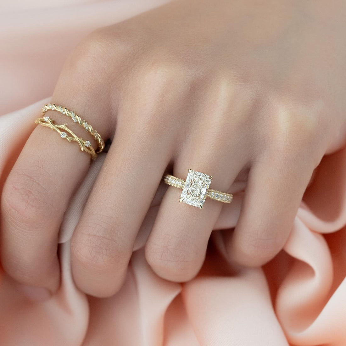 Radiant cut lab grown diamond ring in yellow gold on a domed pave band with milgrain edges