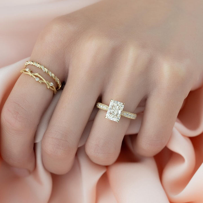 Radiant cut lab grown diamond ring in yellow gold on a domed pave band with milgrain edges