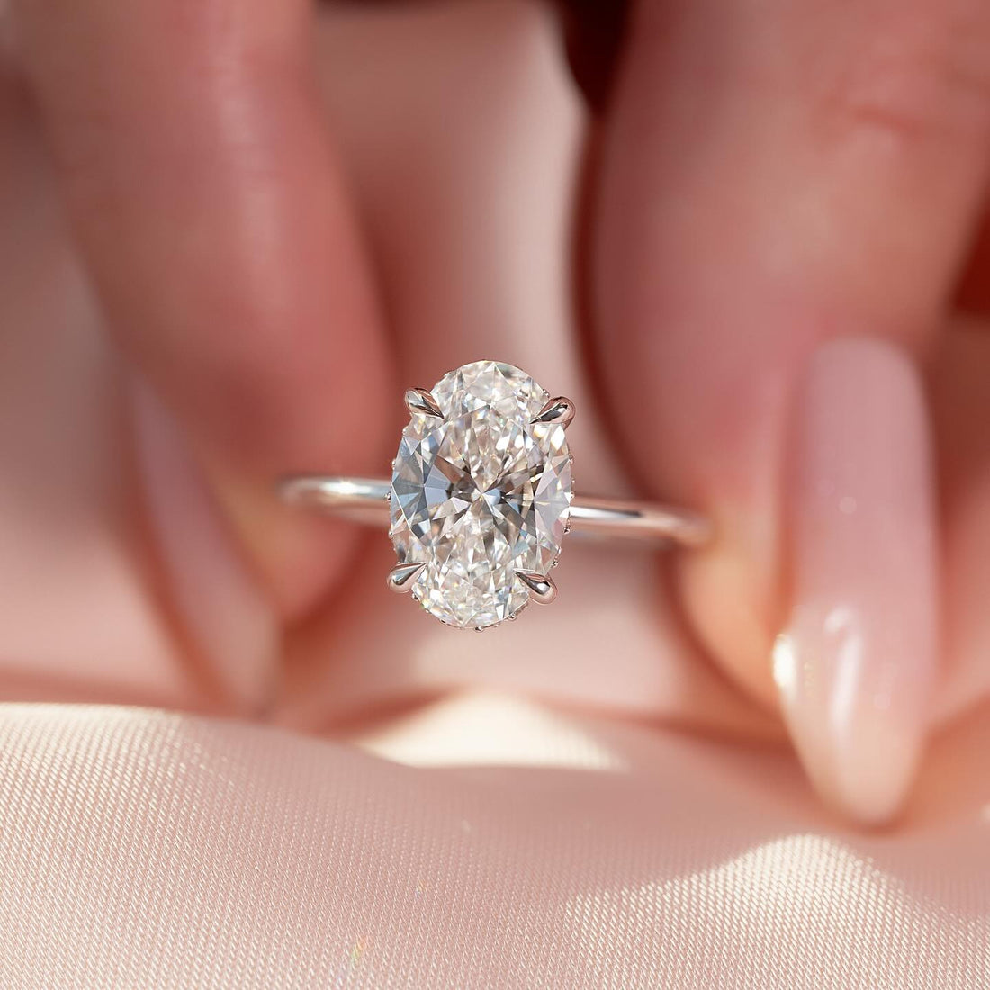 Oval cut lab grown diamond solitaire ring with tapered claws on a fine white gold wire band