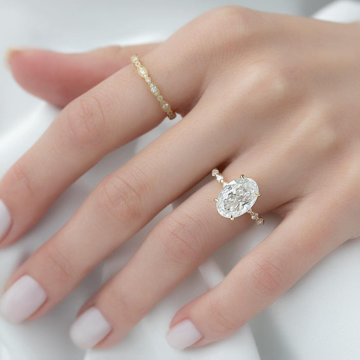 Oval lab grown diamond ring with concealed halo worn on the hand