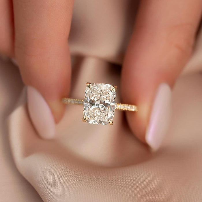 Elongated cushion cut lab grown diamond ring with pave shank in yellow gold