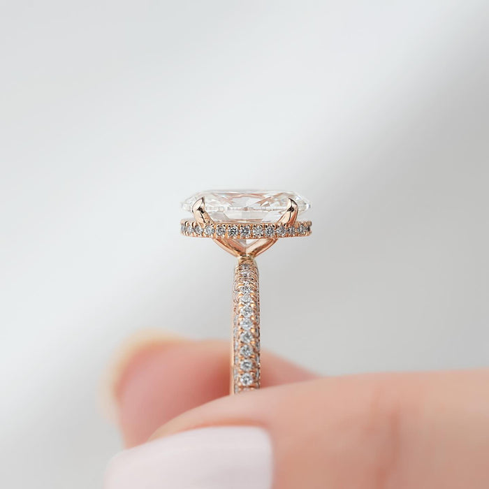 Oval cut lab grown diamond ring in rose gold showing pave on three sides of the shank