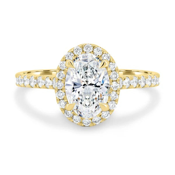 Oval cut lab grown diamond visible halo ring on a pave shoulder band
