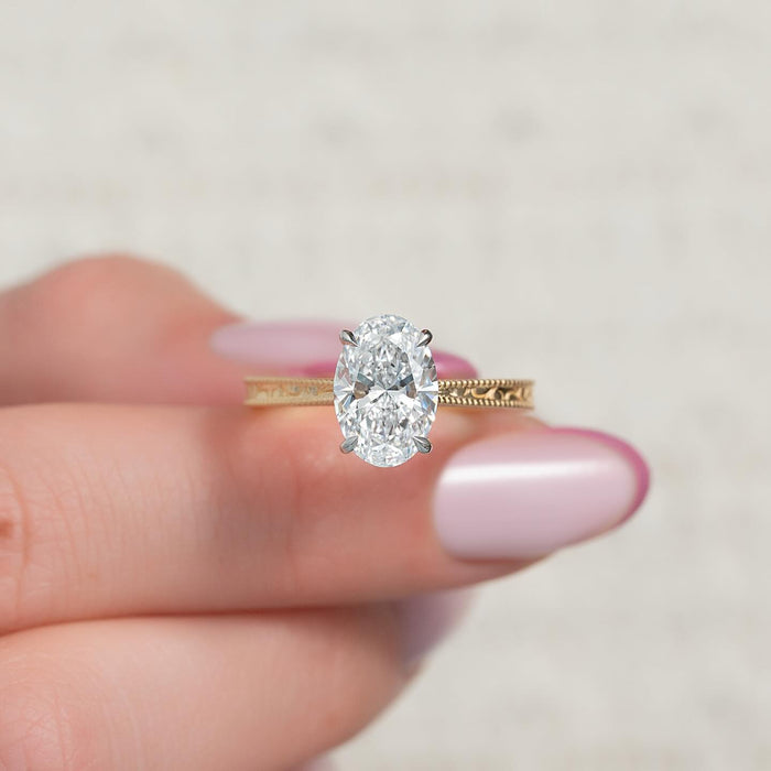 Oval cut lab grown diamond vintage ring with hand engraved milgrain band, front view