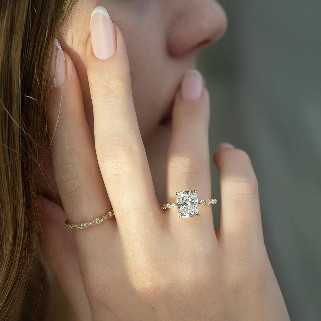 Elongated cushion cut lab grown diamond ring in yellow gold with spaced accents on the shank