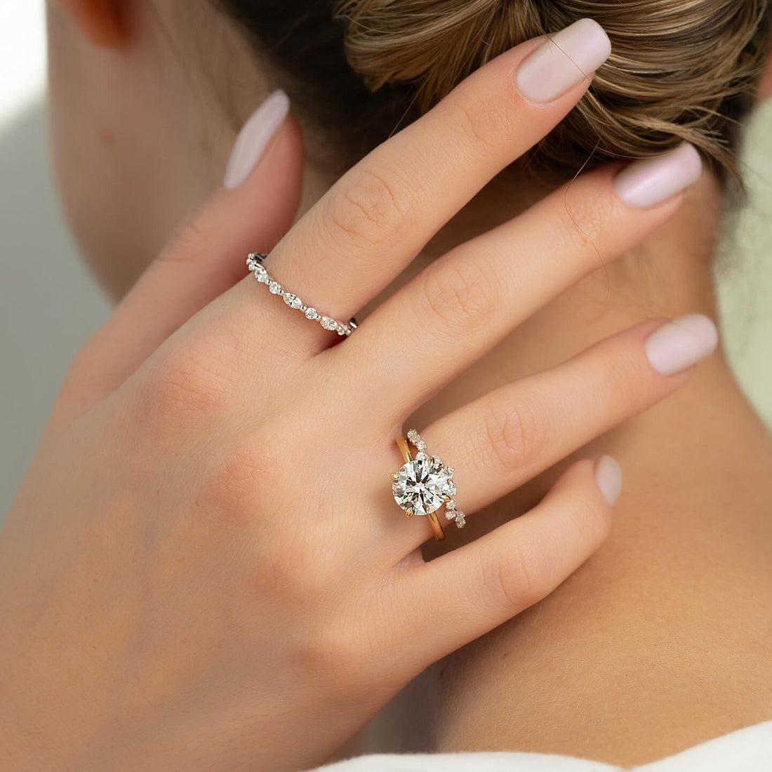 Round lab grown diamond ring with curved graduated accent shoulders in rose gold