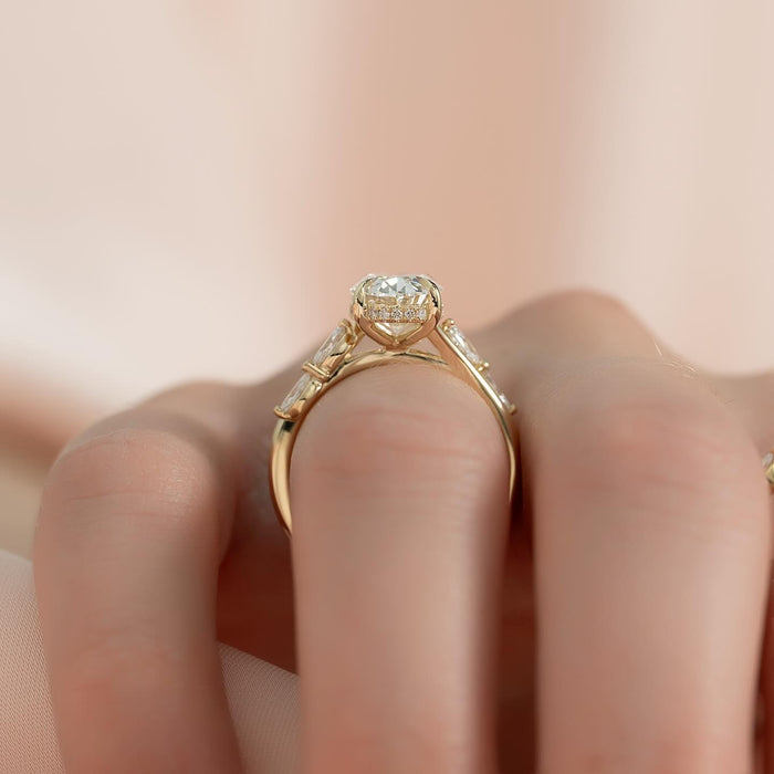 Cluster of three round diamonds at each shoulder of the oval