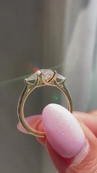 Oval cut lab grown diamond trilogy ring in trellis setting