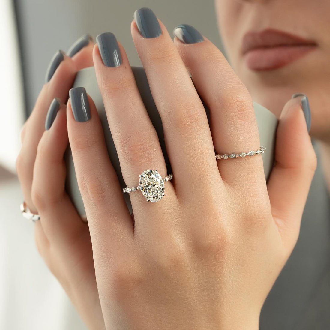 Oval cut lab grown diamond ring in white gold with alternating marquise and round accents on the shank