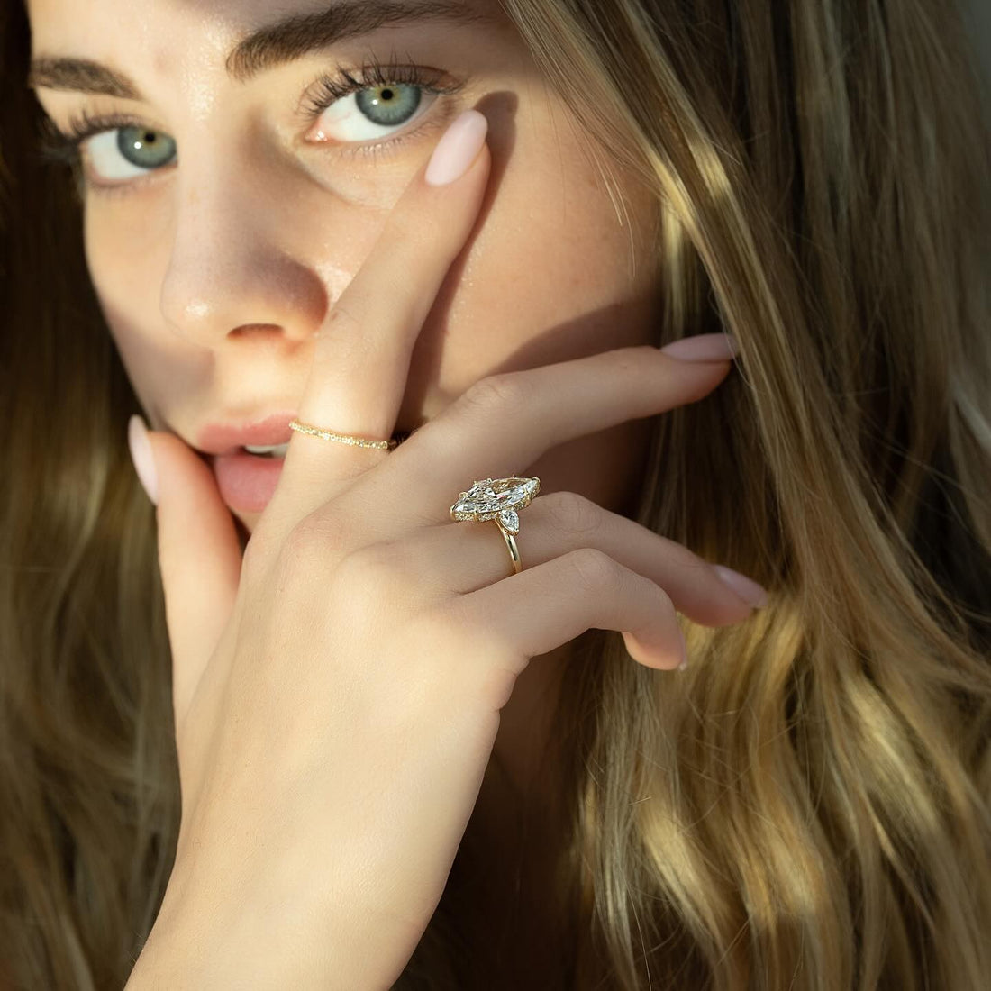 Marquise cut lab grown diamond ring with calibrated pear side stones in yellow gold