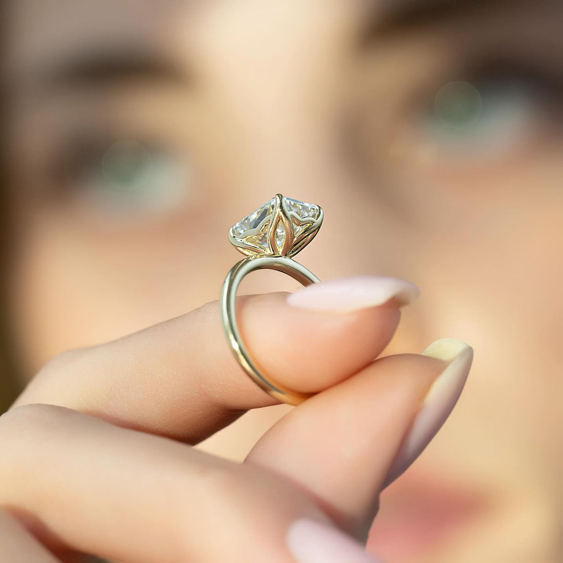 Cushion cut lab grown diamond ring in a tulip head setting on a fine yellow gold band