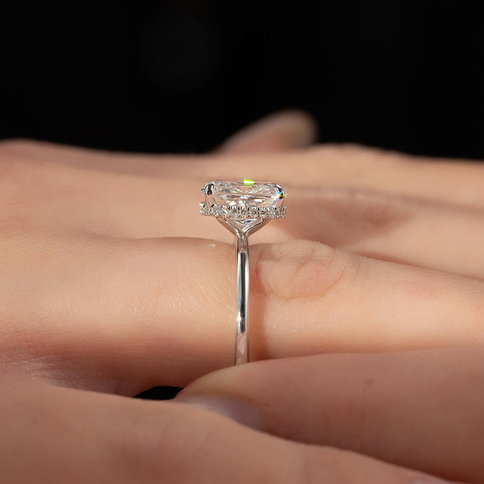 Elongated cushion diamond set sideways across the finger in four claws