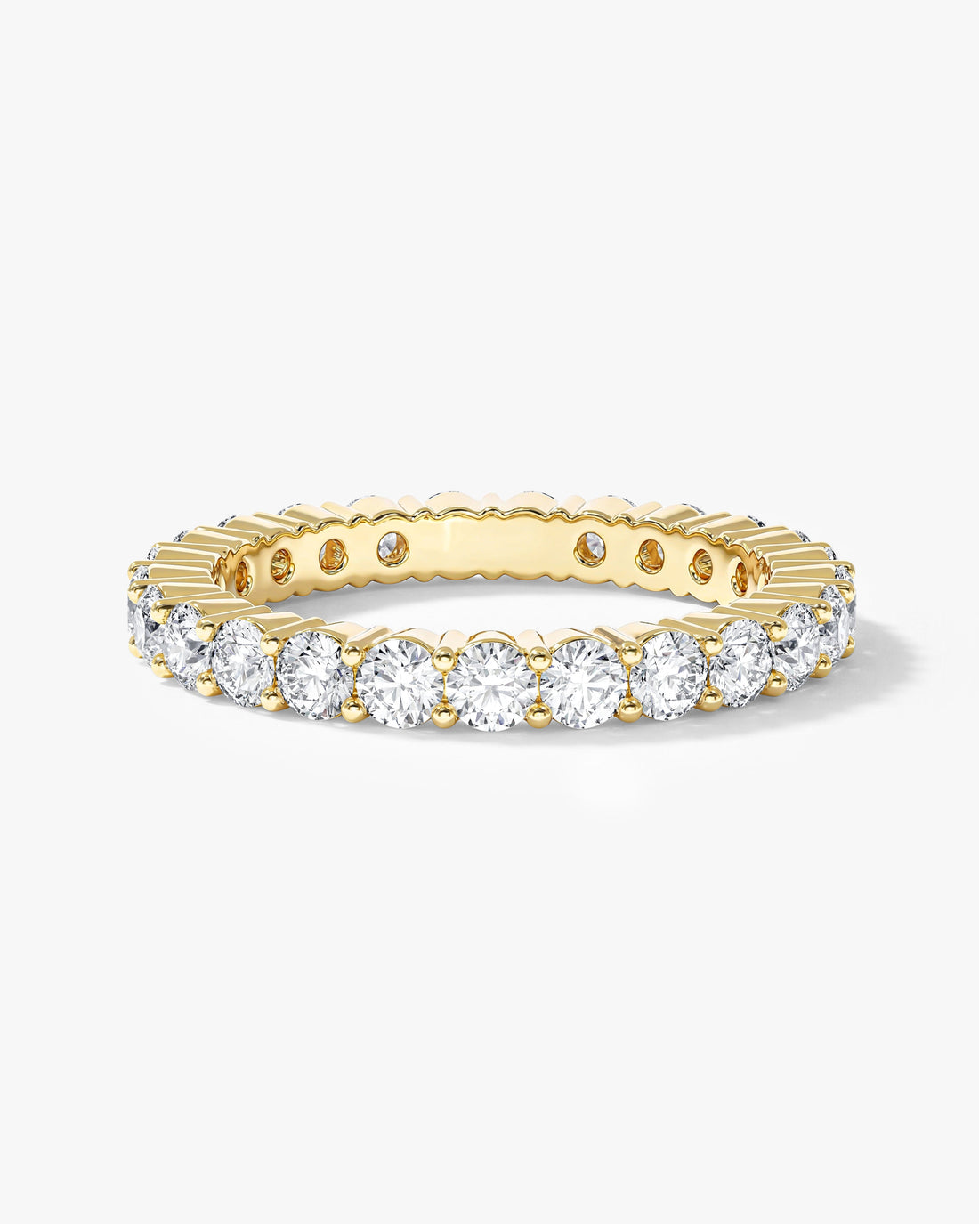 2.5mm round moissanite faceted eternity wedding band in yellow gold, front view