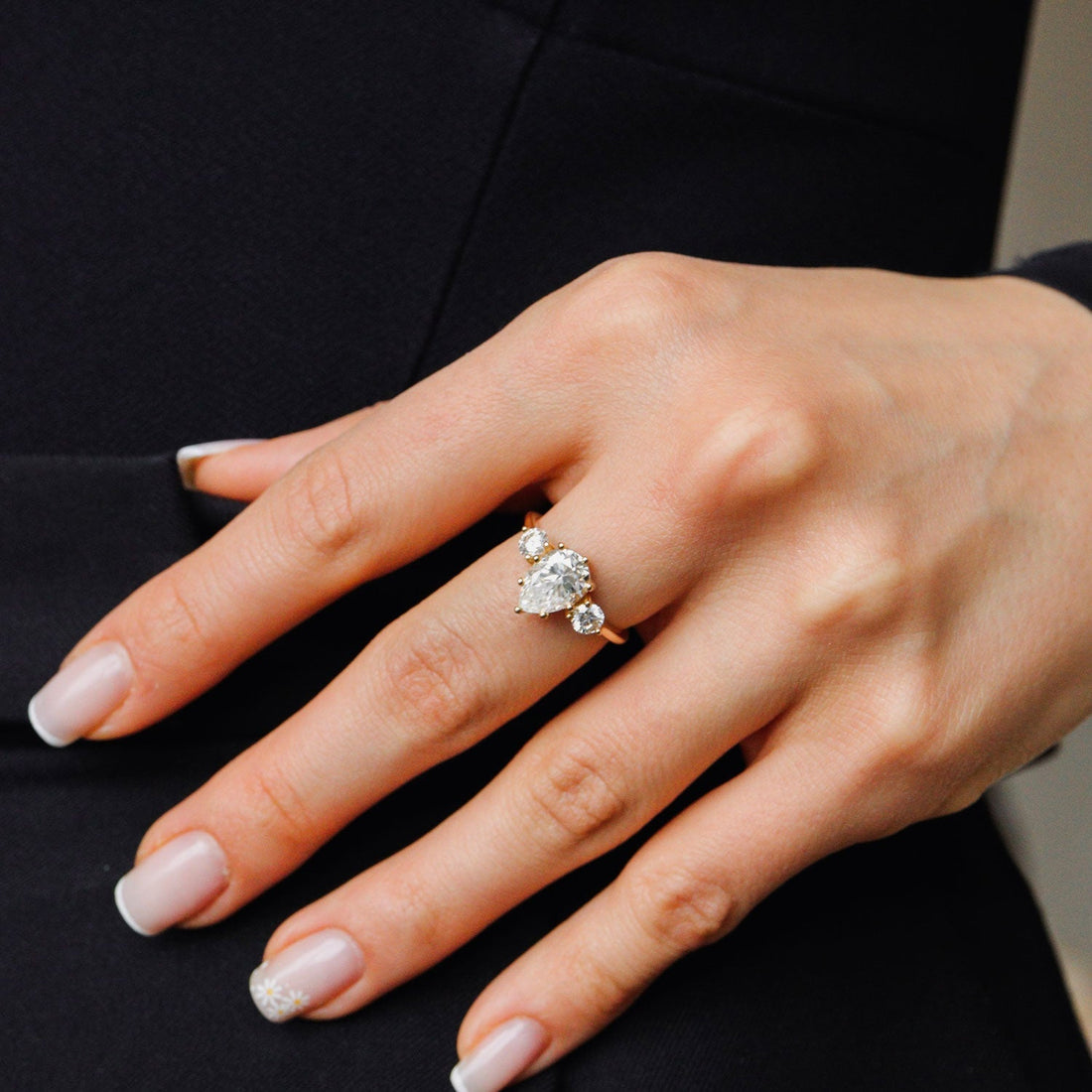 Pear cut lab grown diamond three stone engagement ring with round side stones