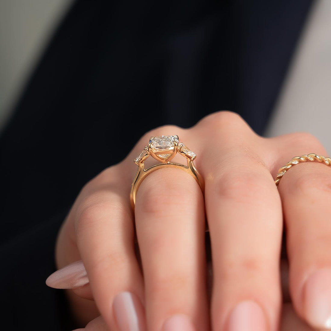 Elongated cushion moissanite three stone pear ring side profile in rose gold