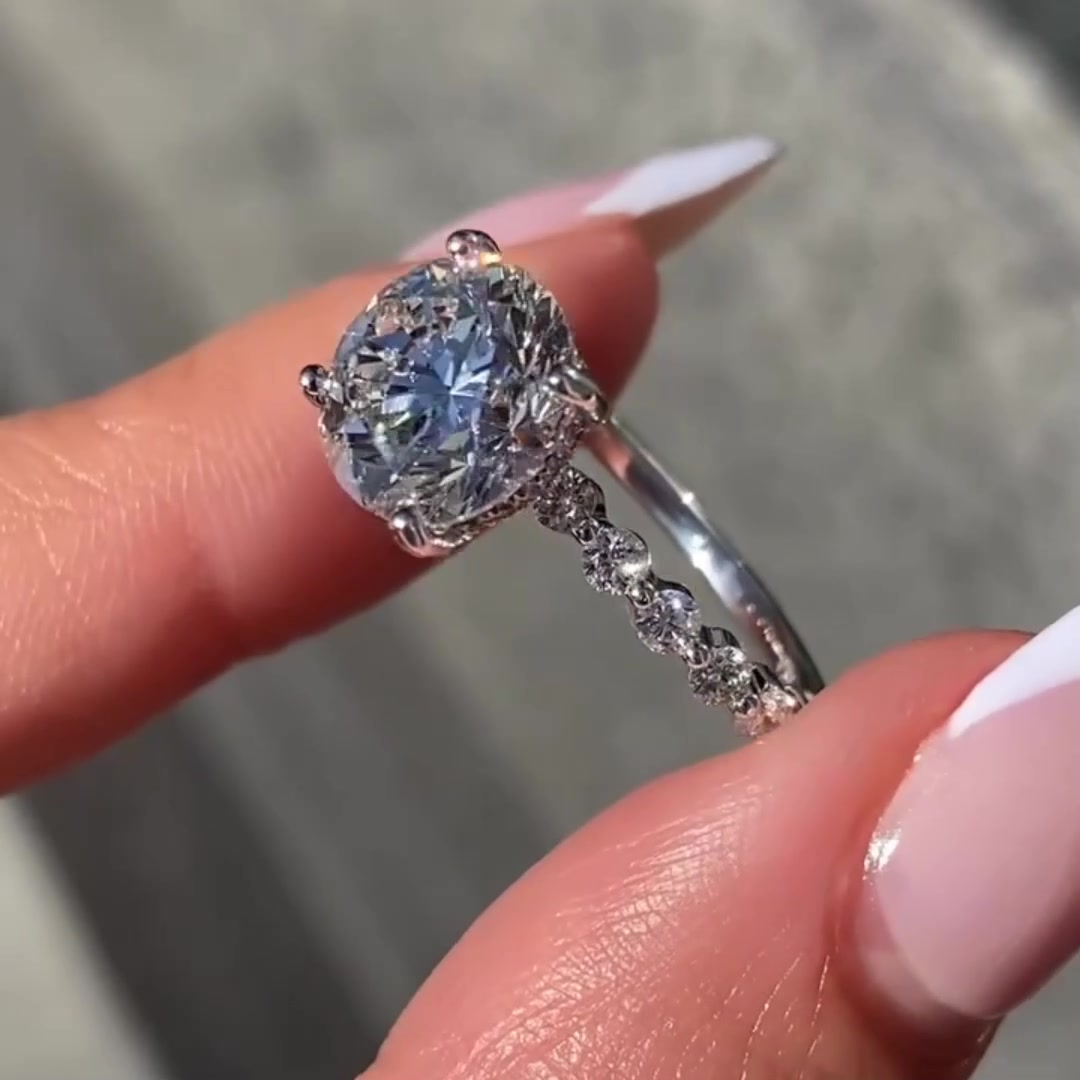 Round brilliant cut moissanite engagement ring with hidden halo in white gold