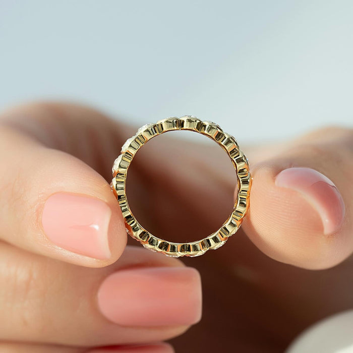 Oval moissanite bezel full eternity band circle view in yellow gold