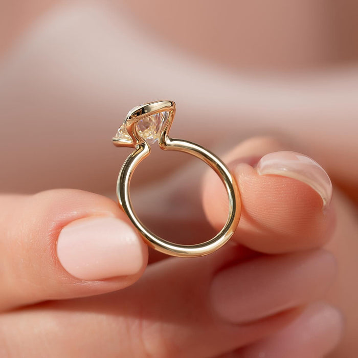 Elongated cushion moissanite half bezel solitaire ring side profile in yellow gold