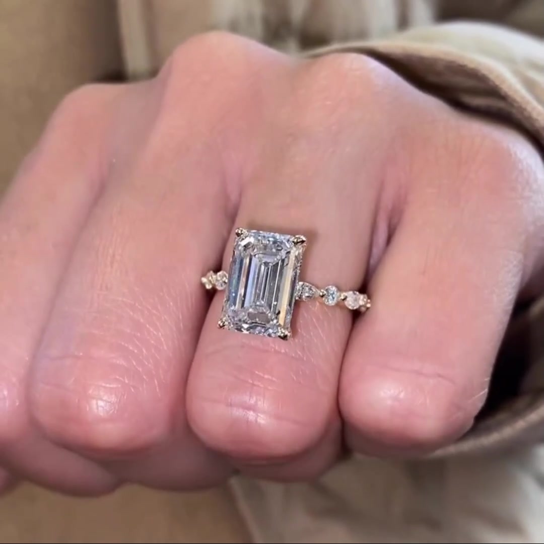Emerald cut moissanite solitaire engagement ring with hidden halo in 14K gold