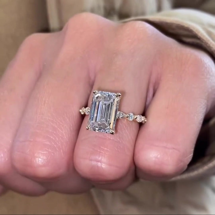 Emerald cut moissanite solitaire engagement ring with hidden halo in 14K gold