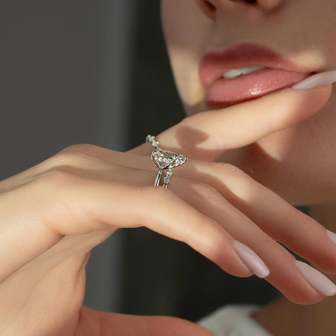 Pear moissanite spaced marquise band ring profile worn on hand in white gold