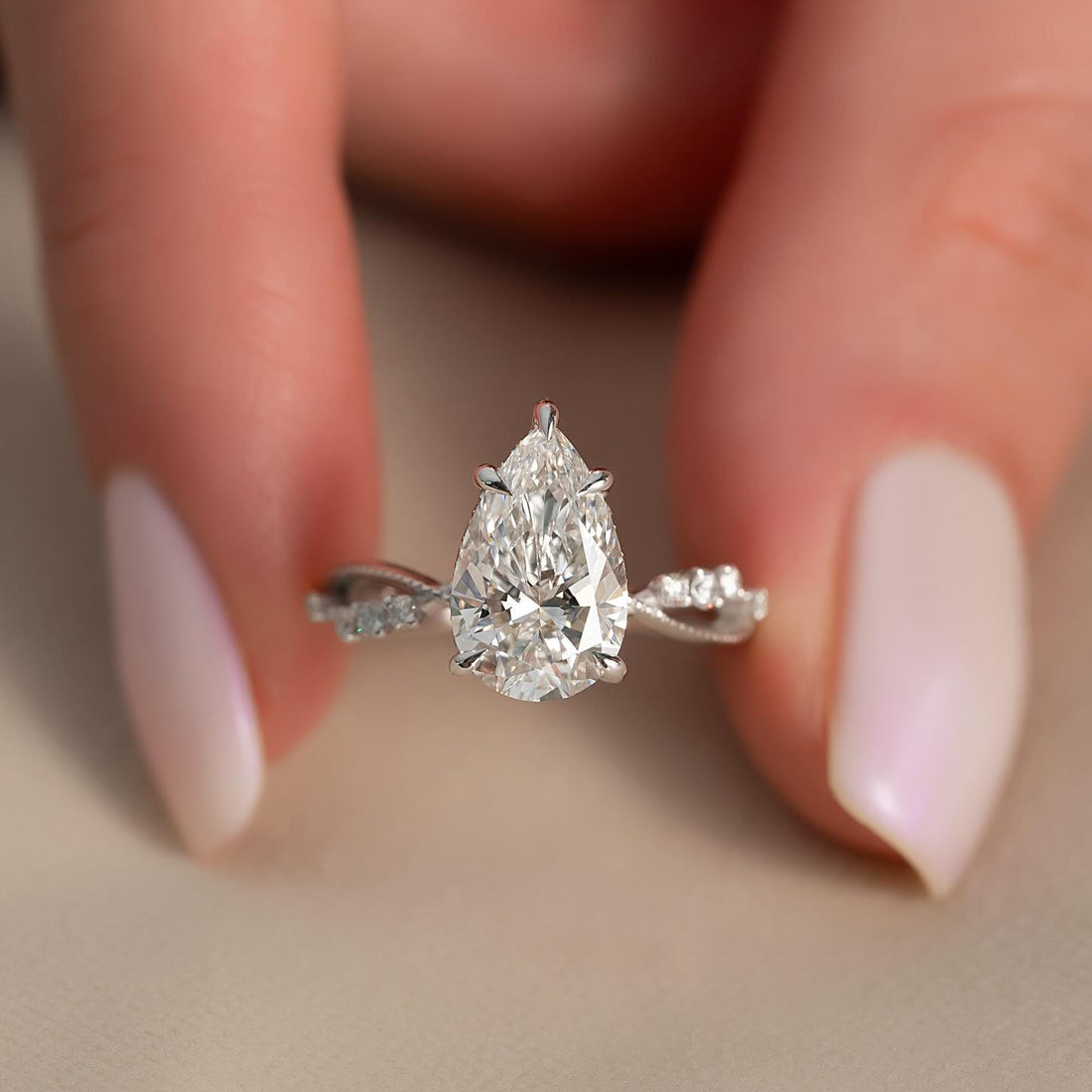Pear moissanite hidden halo ring with vine accent band in white gold