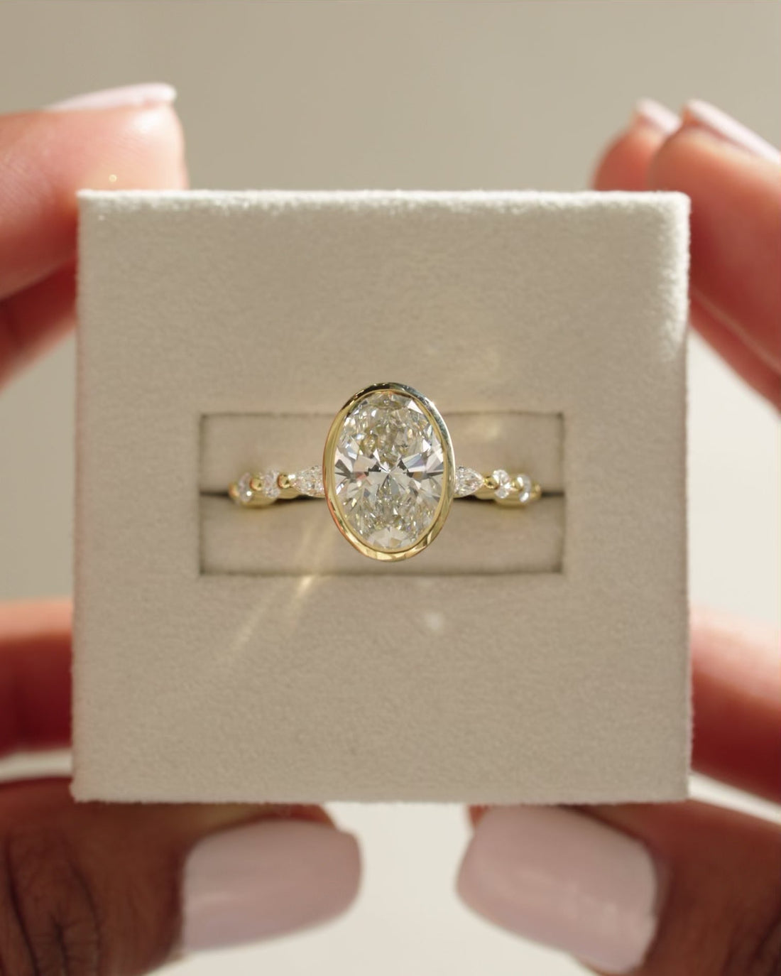 Oval Cut Moissanite Bezel Set Engagement Ring with Marquise and Round Accents - view 1
