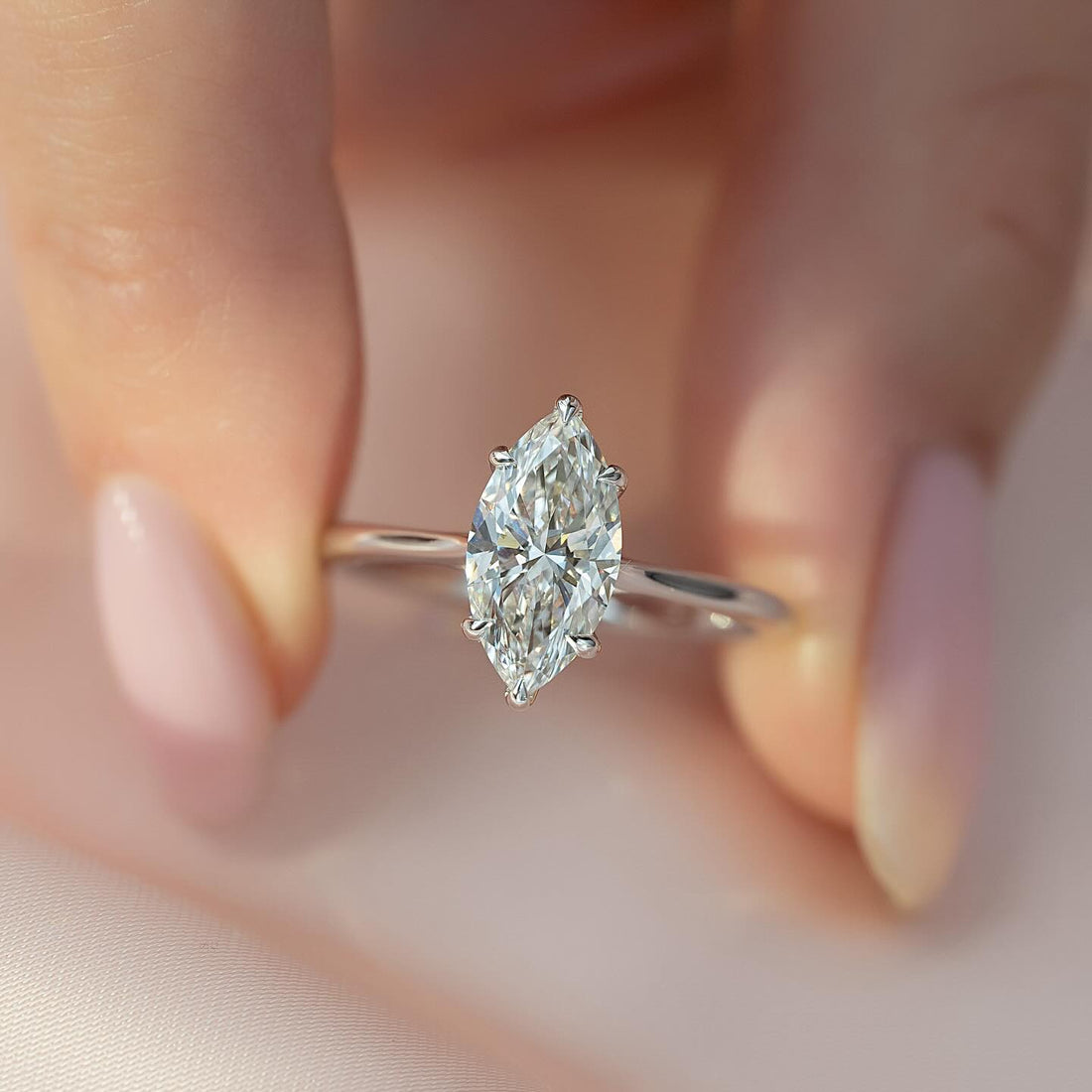 Marquise Moissanite Six Prong Thin Band Solitaire Ring in 14K Gold on hand