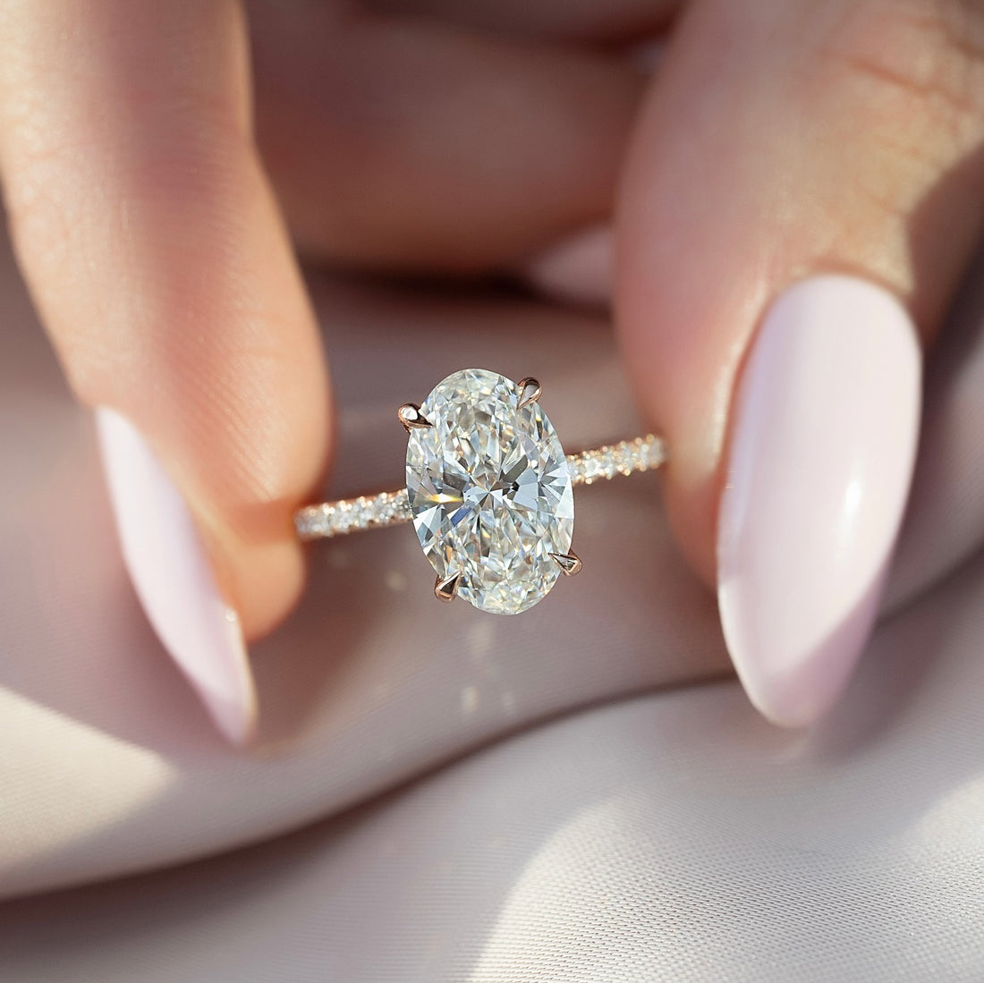 Oval Moissanite Pave Band Solitaire Ring on hand in 14K Gold