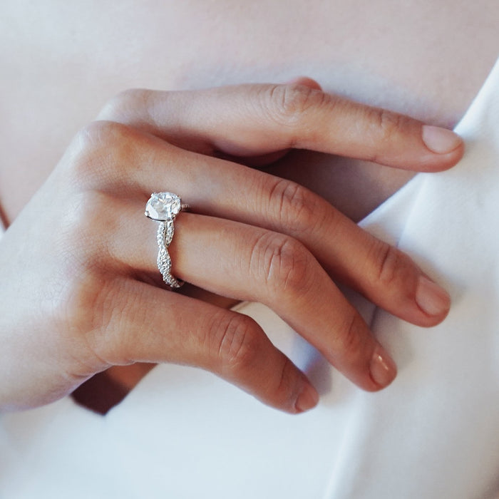 Twisted pave band engagement ring seen on the finger